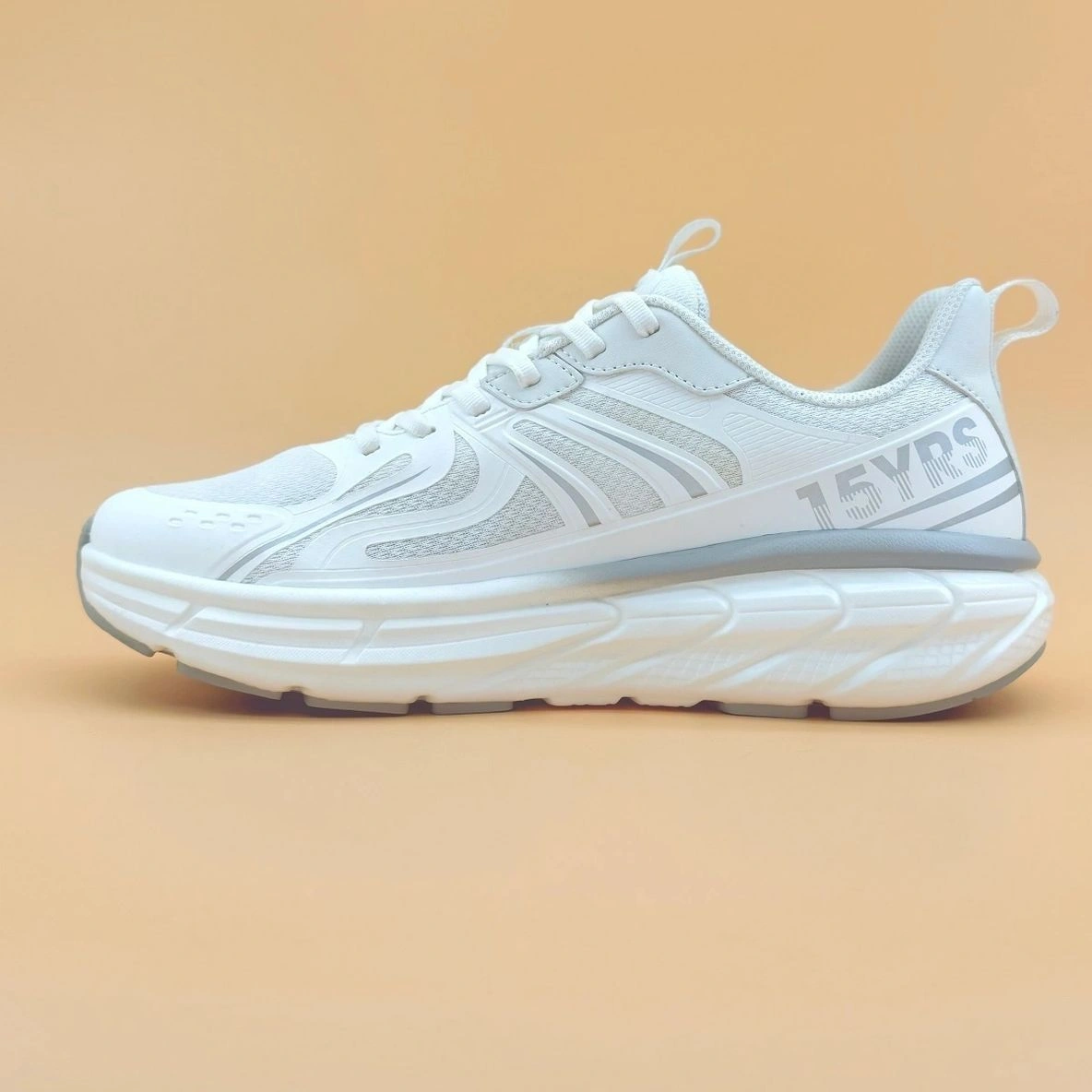 White athletic shoe with "15 YRS" text.