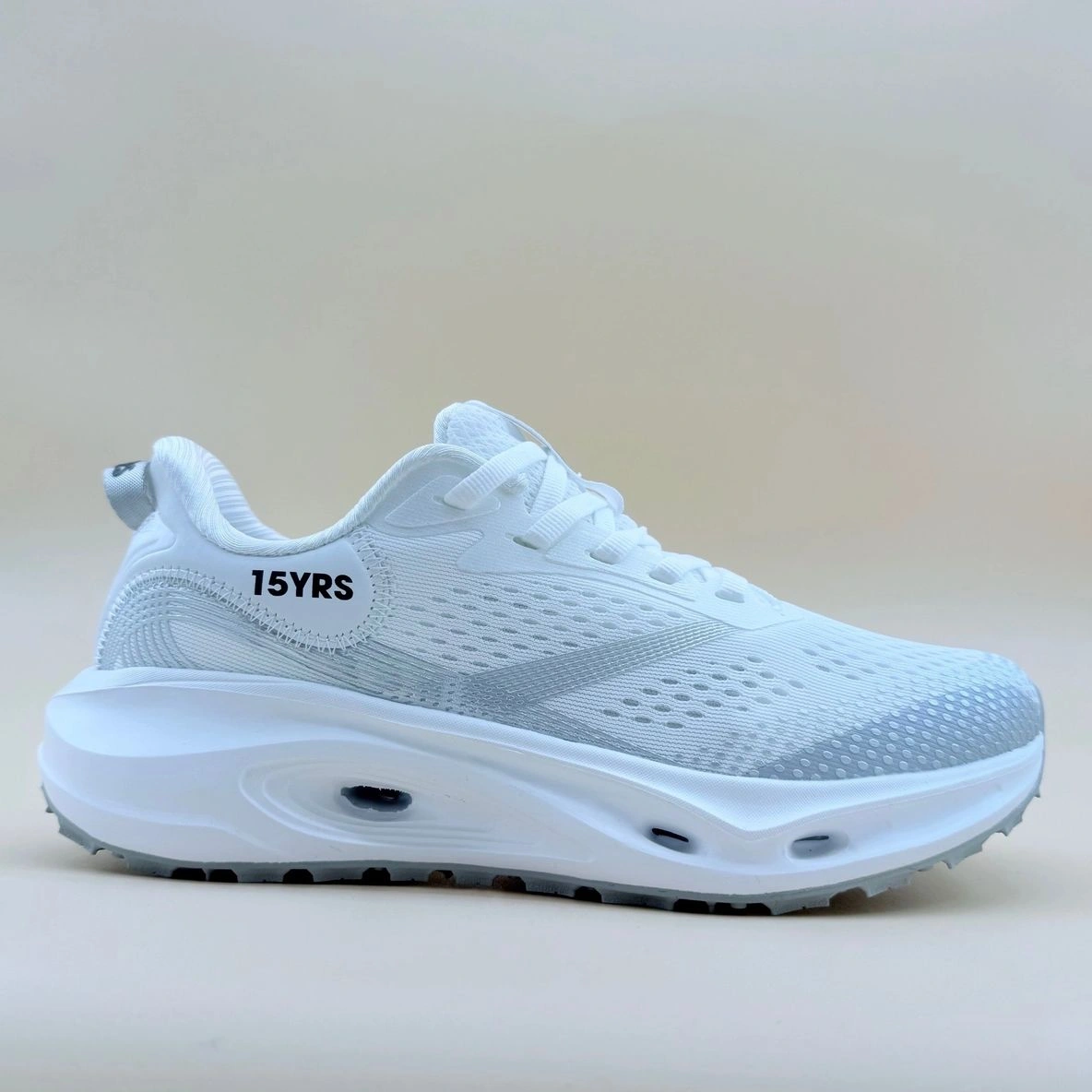 White athletic shoe with "15YRS" text.