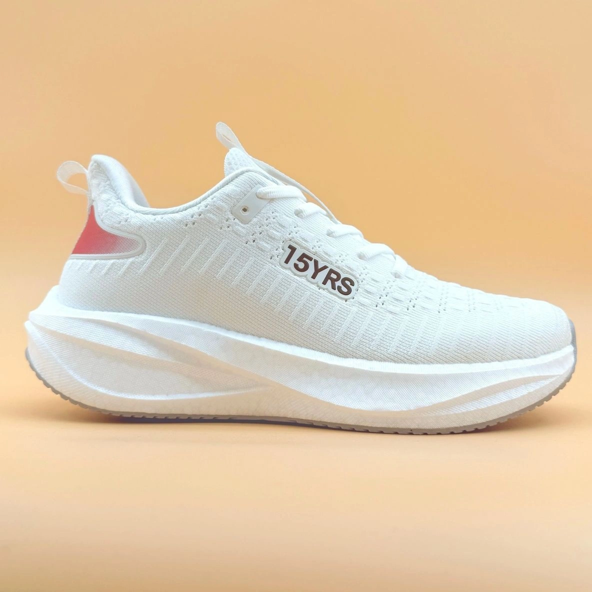White sneaker with "15YRS" text on side.