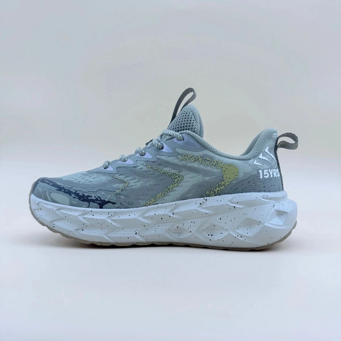 Gray athletic shoe with thick white sole.