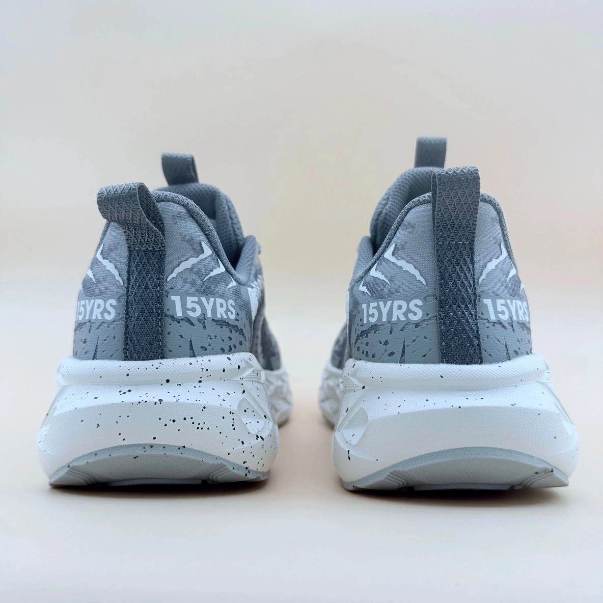 Gray sneakers with "15YRS" text on back.